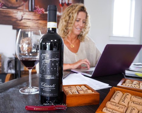 Nina Snow leading a virtual guided wine tasting with a bottle of Chianti Riserva from Ravazzi.