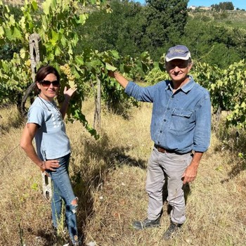 Alessandro and Simona posing in front of the vines