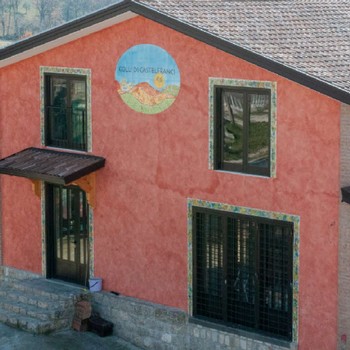 The main house  with a pink fresco wall at Colli di Castelfranci in Campania, Italy