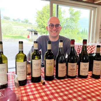 Tasting Rubinelli Vajol wines with all the bottles lined up on a red and white checked table cloth