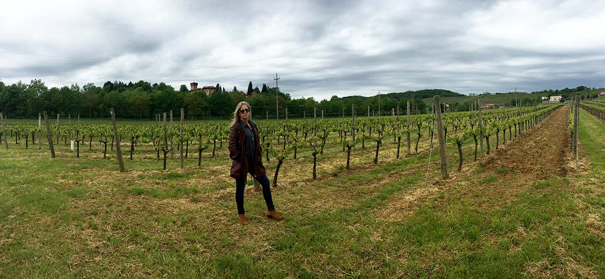 Nina Snow of DOCG Imports standing in Italian vineyard at Villa Parens wines